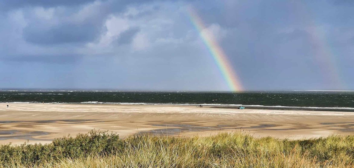 View onto a rainbow at the beach from the Lighthouse on Texel, Netherlands.